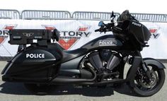 a police motorcycle parked in front of a wall