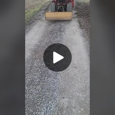 a tractor is driving down a dirt road