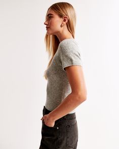 Elevate your everyday style with the Abercrombie & Fitch Women's Crew Sweater Tee in a chic Light Gray. This slim-fitting, short-sleeve tee is crafted from a luxuriously soft sweater yarn fabric, ensuring both comfort and a flattering fit.

- **Size**: Medium
- **Material**: Polyester, Nylon, Acrylic
- **Color**: Light Gray
- **Gender**: Female
- **Features**: Crew neckline, rib trim details along the banded hem and cuffs

Ideal for seamless transitions from office wear to evening outings, this Trendy Crew Neck Short Sleeve Top For Casual Gatherings, Fitted Short Sleeve Tops With Ribbed Cuffs, Fitted Knit T-shirt With Short Sleeves, Fitted Crew Neck Knit T-shirt, Fitted Knit Crew Neck T-shirt, Fall Short Sleeve Knit Top With Ribbed Collar, Fitted Knit T-shirt With Crew Neck, Fall Ribbed Collar Knit Top With Short Sleeves, Trendy Short Sleeve Knit Top With Ribbed Neckline