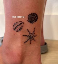 the foot has three seashells on it and one shell is in black ink