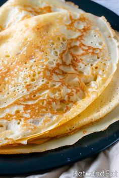 three pancakes are sitting on a blue plate