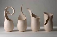 three white vases sitting next to each other