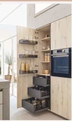 an open kitchen cabinet with drawers and shelves