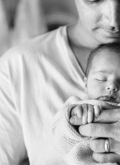 a woman holding a baby in her arms with the caption's name on it