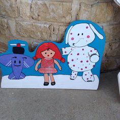 a child's bed with an elephant and a girl standing next to each other