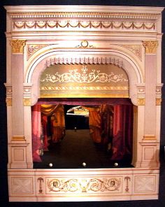 an ornately decorated stage with red curtains