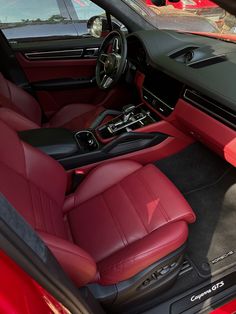 the interior of a car with red leather seats