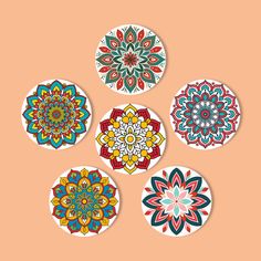 four circular stickers with colorful designs on the top one has an image of a flower