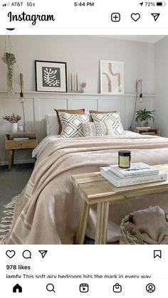 a bedroom with a bed, table and pictures on the wall