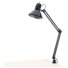 a black desk lamp sitting on top of a white table