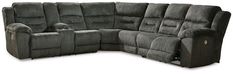 a large sectional sofa with two recliners on the back and one end facing it