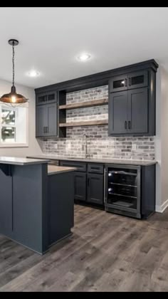 a kitchen with gray cabinets and an island