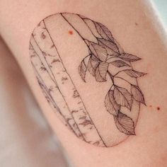 a piece of bread with leaves on it is shown in this tattoo design by the artist