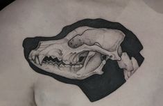 a close up of a person's chest with a large animal skull on it