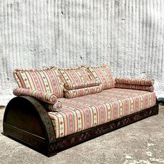 a couch sitting on top of a wooden floor next to a white wall with stripes