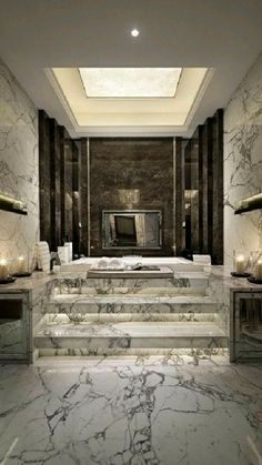 an elegant bathroom with marble steps leading up to the bathtub