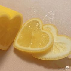 two lemon halves cut in half on a table