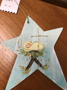 a wooden star ornament with an image of a woman on it