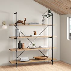 a book shelf in the corner of a room with wood floors and white walls, next to a window