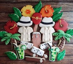 decorated cookies are arranged in the shape of a golf scene with palm trees and hats