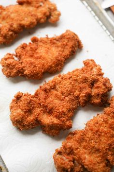 four fried chicken pieces on a tray ready to be cooked