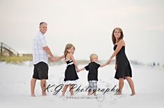 a family holding hands on the beach