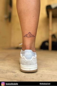 a person with a small tattoo on their leg