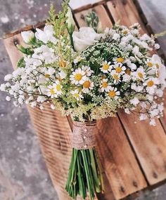 a bouquet of daisies and other flowers in a vase