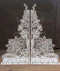 an intricately designed metal gate with flowers and leaves on the sides, in front of a