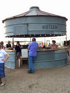 people are standing at an outdoor bar with the caption, best use of grain bin i've seen