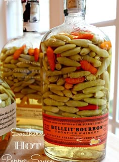 a bottle filled with green beans and carrots