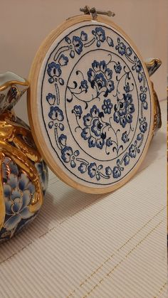 two blue and white vases sitting next to each other on top of a table