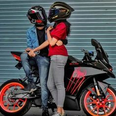 two people standing next to each other on a motorbike with helmet on it