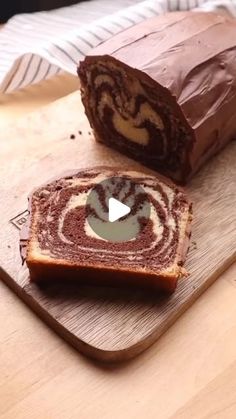 a loaf of chocolate swirl bread sitting on top of a cutting board