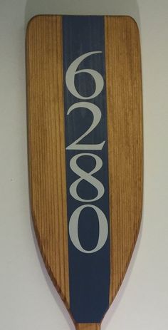 a wooden paddle hanging on the wall with an ovo logo painted on it's side