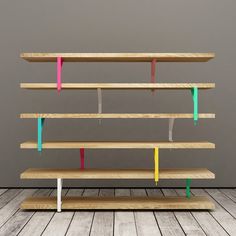 three different colored shelves on top of each other, with one shelf in the middle