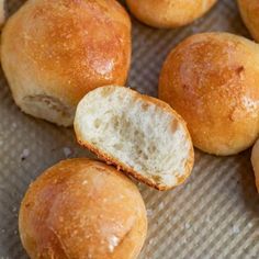 some bread rolls sitting on top of a piece of paper