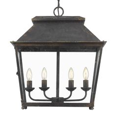 an old fashioned hanging light fixture with three candles