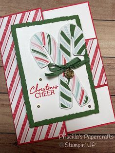 a close up of a christmas card with candy canes on the front and bottom