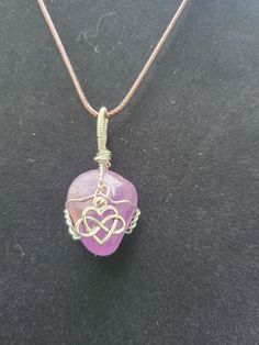 "Wire wrapped Amethyst with Infinity Heart charm with 20\" adjustablewaxedcottoncordnecklace. Please note this stone is much more purple than it appears in picture, it is not pink at all" Adjustable Hand Wrapped Heart Jewelry, Adjustable Purple Jewelry With Heart Charm, Adjustable Purple Necklaces With Heart Beads, Gift Wire Wrapped Necklace With Waxed Cord, Purple Adjustable Heart Pendant Necklace, Adjustable Hand-wrapped Amethyst Crystal Necklace, Purple Jewelry With Adjustable Cord As Gift, Purple Jewelry With Adjustable Cord For Gift, Wire Wrapped Jewelry With Waxed Cord As Gift