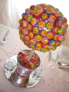 there is a candy centerpiece on the table with many candies in it,