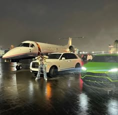 a man standing in front of a limousine next to a green car and an airplane