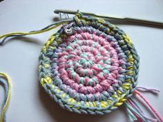 a crocheted round purse sitting on top of a table