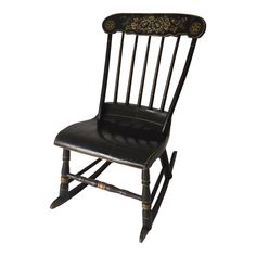 an old fashioned rocking chair with black leather upholstered seat