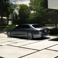 a silver car parked in front of a building