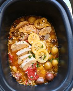 a slow cooker filled with meat and vegetables