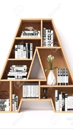 a wooden book shelf with books on it and a vase in the middle filled with flowers