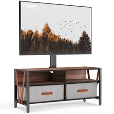 a flat screen tv sitting on top of a wooden entertainment center with two baskets underneath it