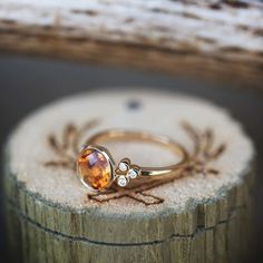 a close up of a ring on top of a piece of wood