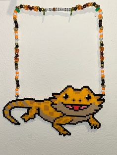 a beaded necklace with an image of a cat hanging from it's side